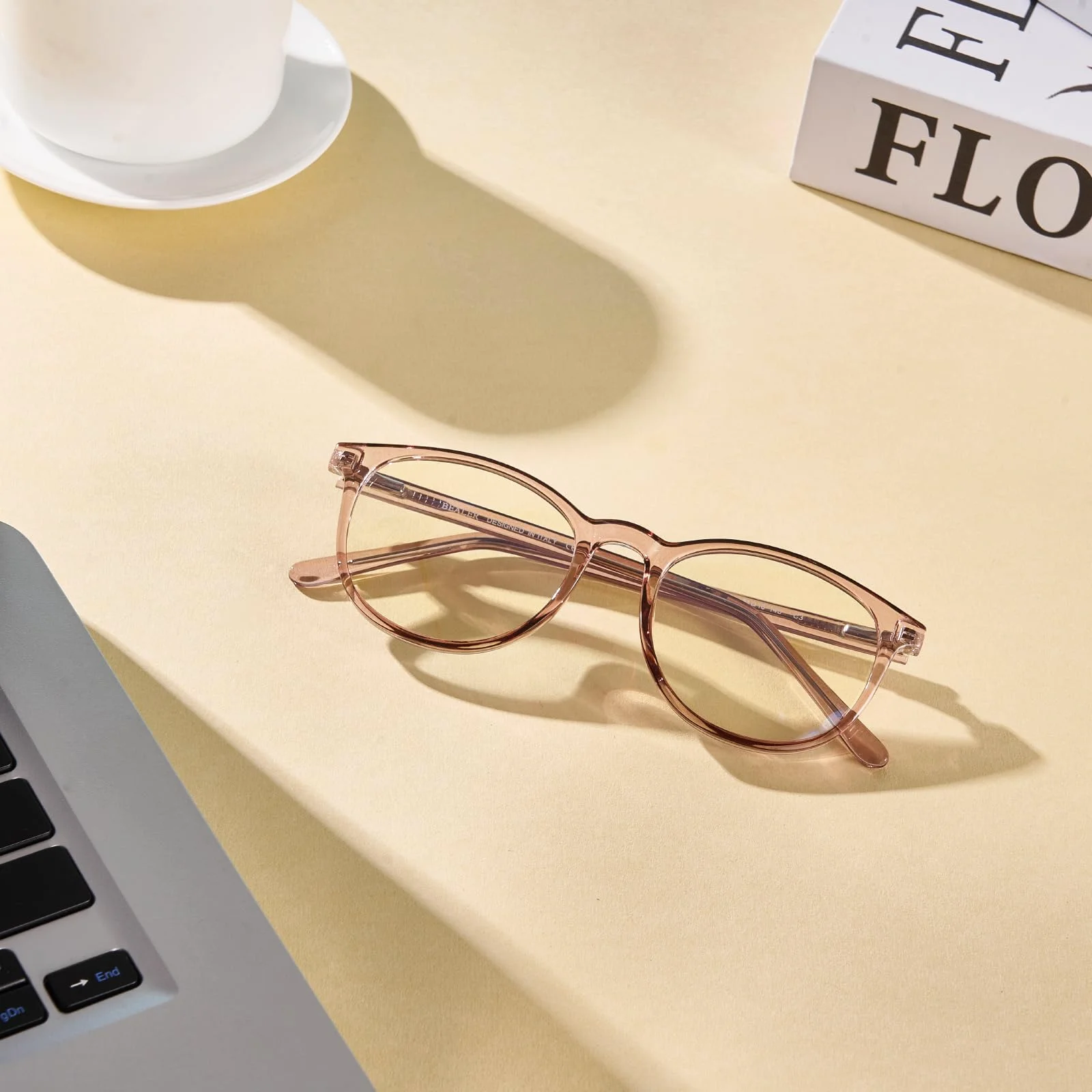 The BL9001 screen frame in flesh pink, set down beside a laptop